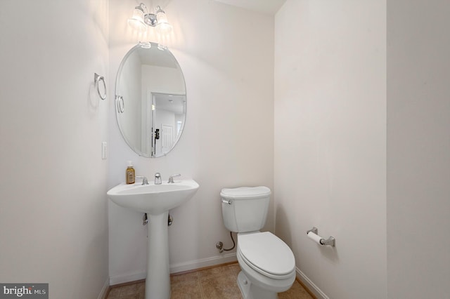 bathroom featuring tile patterned flooring and toilet