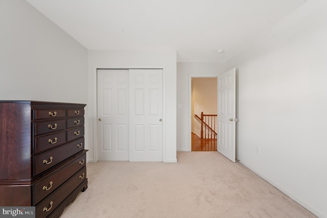 bedroom featuring a closet and light colored carpet