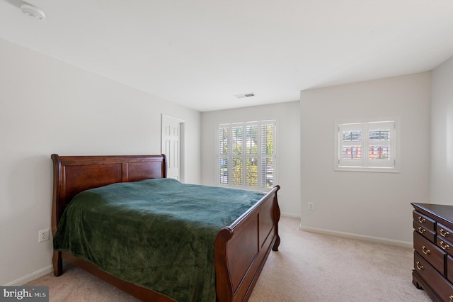 bedroom featuring light carpet, visible vents, and baseboards