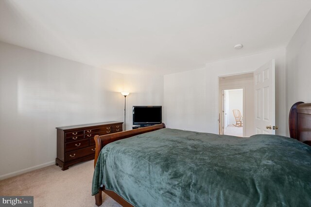 bedroom featuring light colored carpet