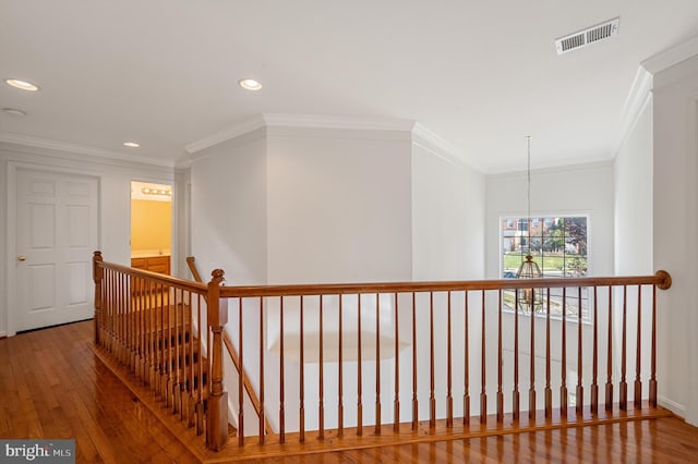 hall featuring ornamental molding and wood-type flooring