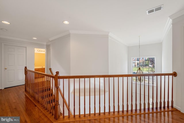 hall with recessed lighting, visible vents, an upstairs landing, wood finished floors, and a chandelier