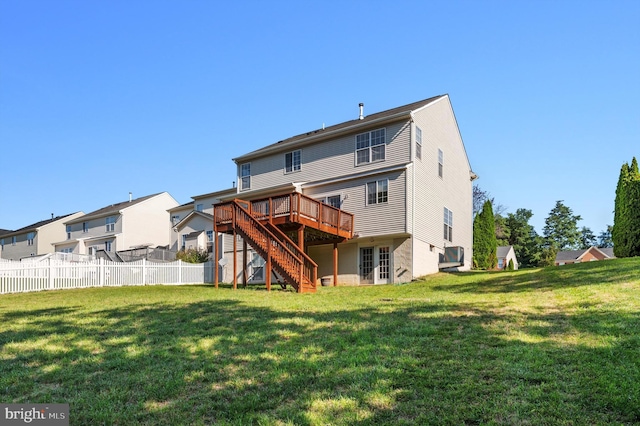 back of house featuring fence, stairway, a lawn, and a wooden deck