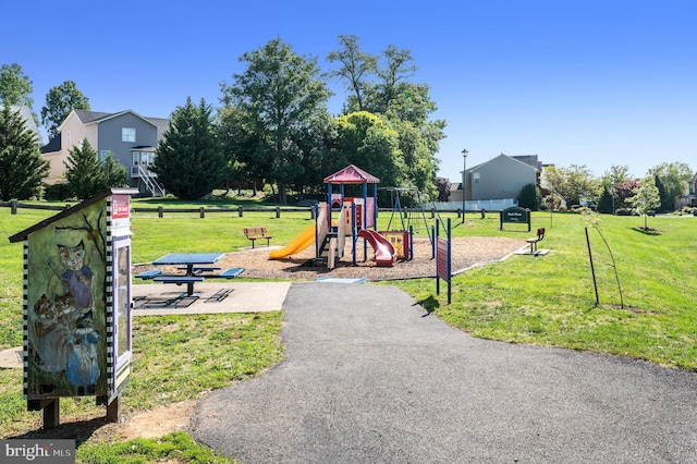 view of jungle gym featuring a lawn