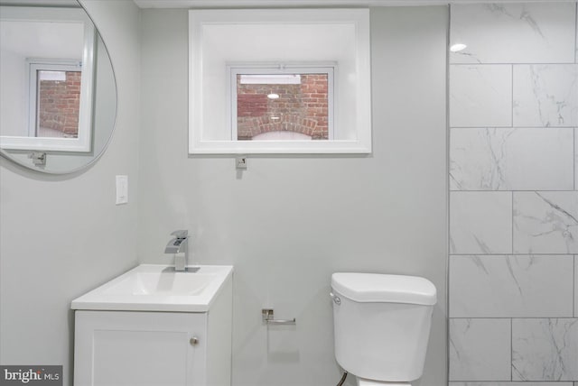 bathroom featuring toilet and vanity