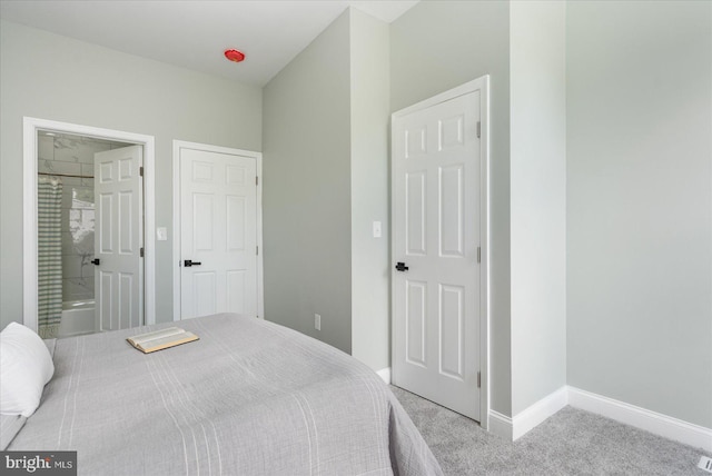 bedroom featuring carpet flooring and connected bathroom