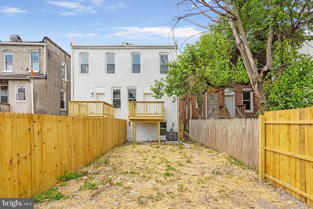 rear view of property featuring central AC