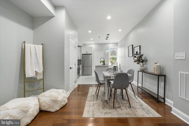 dining room with sink and hardwood / wood-style flooring