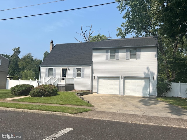 view of front of home featuring a front lawn and a garage