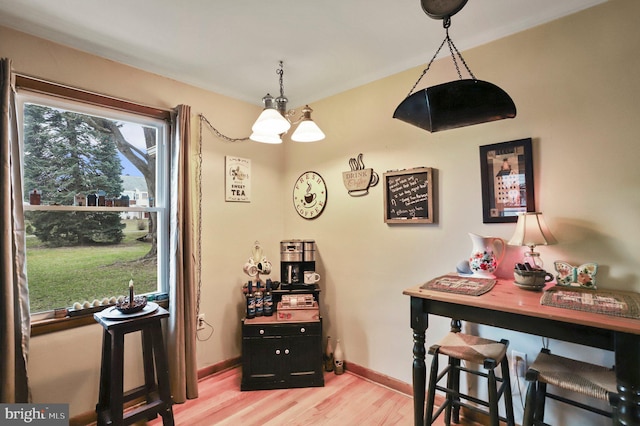 dining room featuring a notable chandelier and light wood-type flooring