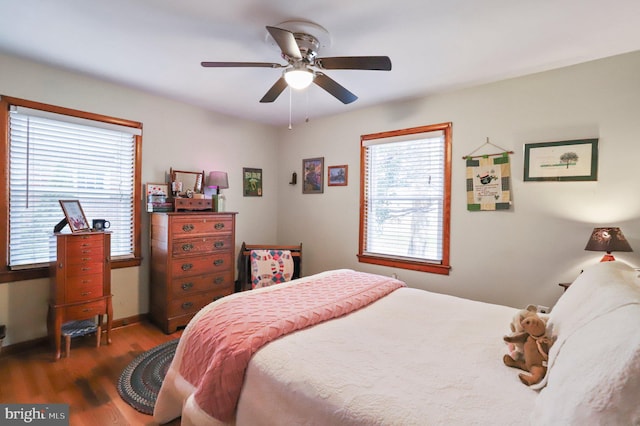 bedroom featuring dark hardwood / wood-style flooring and ceiling fan