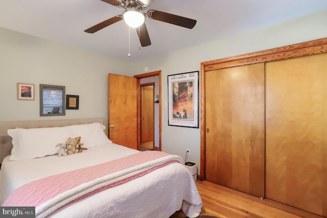 bedroom featuring light hardwood / wood-style flooring, a closet, and ceiling fan