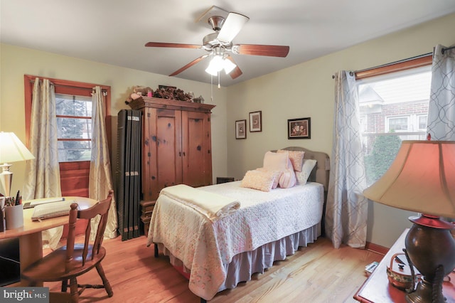 bedroom with ceiling fan and light wood-type flooring