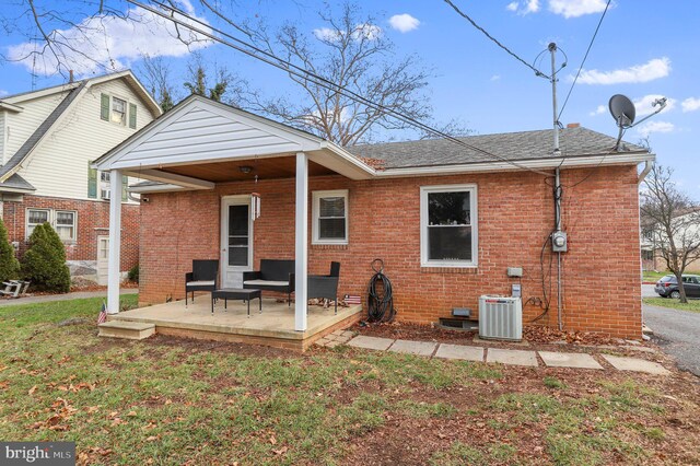 rear view of house featuring central AC unit