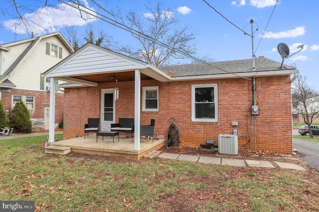 back of property featuring cooling unit, a yard, and a patio area