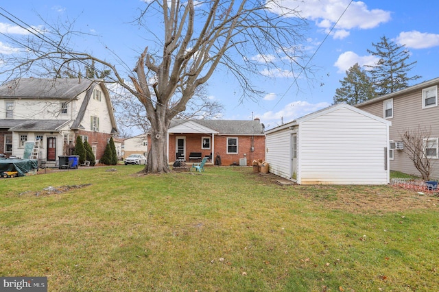 rear view of property featuring a lawn