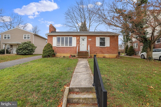 bungalow-style home with a front lawn