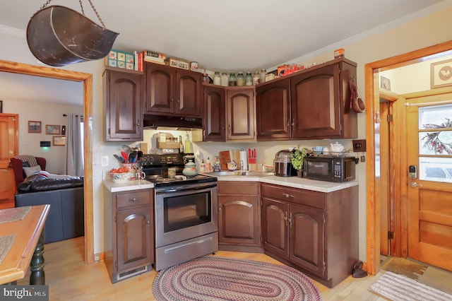 kitchen with stainless steel electric stove, dark brown cabinets, crown molding, and light hardwood / wood-style floors