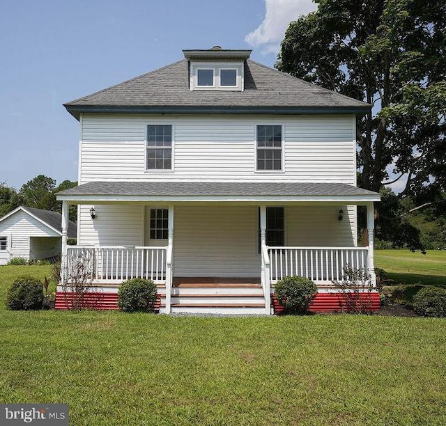 back of house featuring a porch and a yard