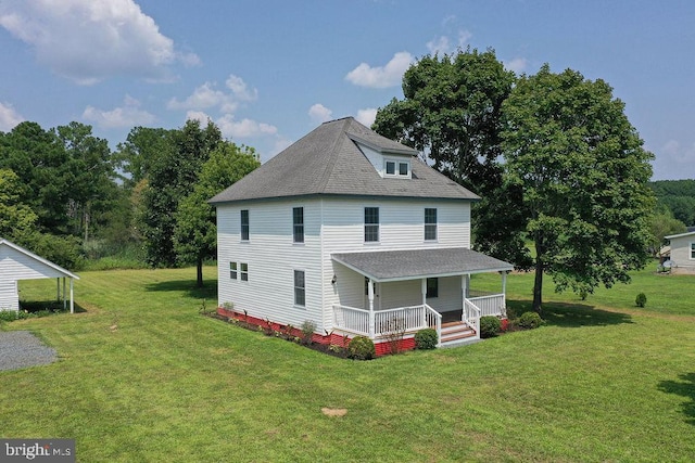 rear view of property featuring roof with shingles, a porch, and a yard