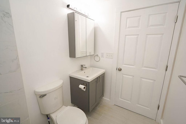 bathroom with tile patterned flooring, toilet, and vanity