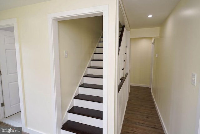 stairway with hardwood / wood-style floors