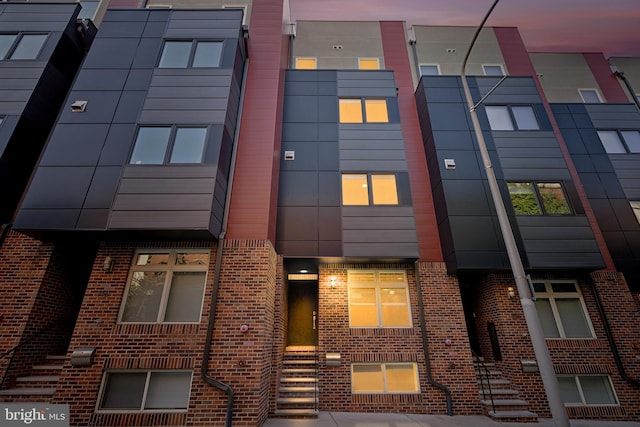 view of outdoor building at dusk