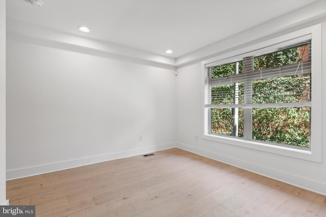 unfurnished room with light wood-type flooring