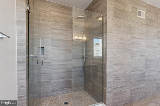 bathroom featuring a shower with shower door