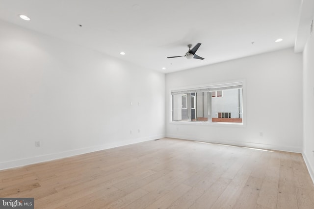 empty room with light hardwood / wood-style flooring and ceiling fan