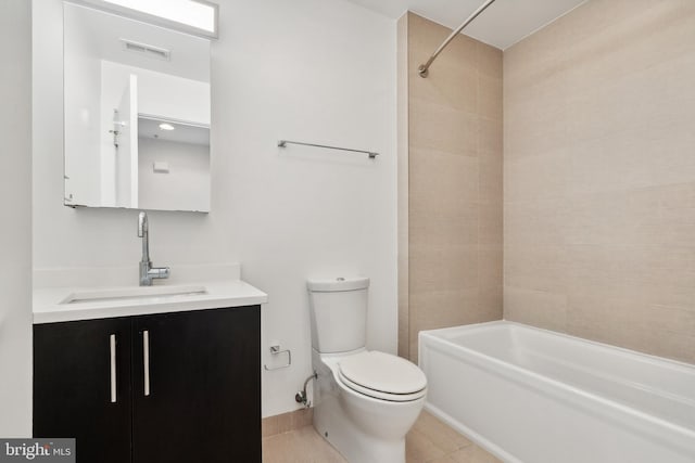 full bathroom featuring tiled shower / bath combo, vanity, toilet, and tile patterned floors