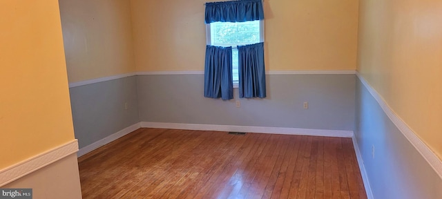 empty room with wood-type flooring