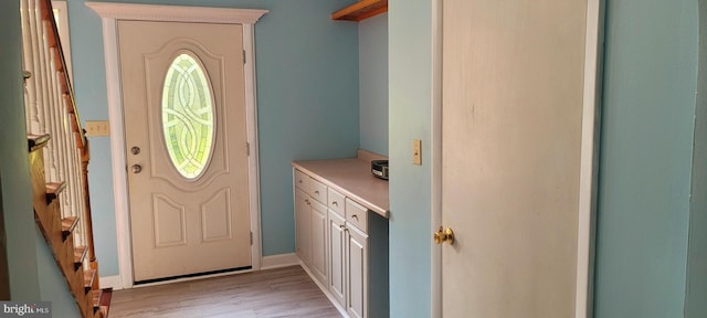 doorway to outside with plenty of natural light and light hardwood / wood-style floors