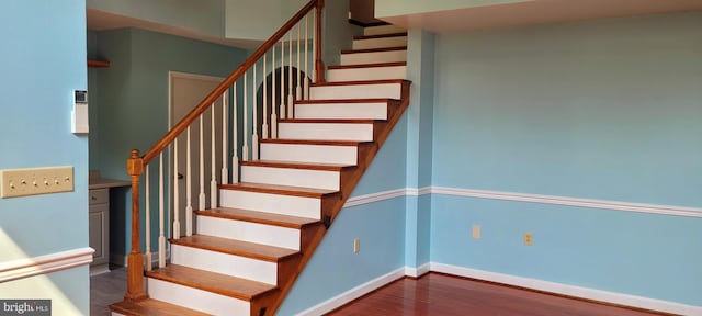 stairs featuring wood-type flooring