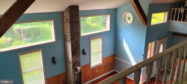 stairway featuring wood walls