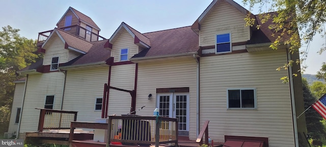 rear view of property with a wooden deck