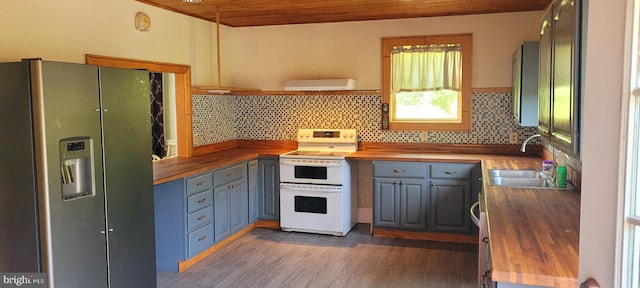 kitchen with wooden counters, stainless steel refrigerator with ice dispenser, white range with electric stovetop, and wooden ceiling