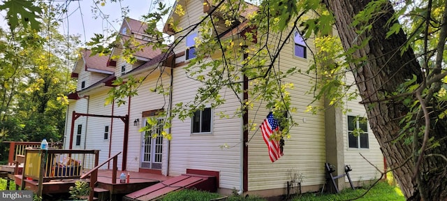 view of property exterior featuring a wooden deck