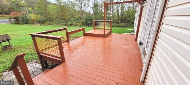 wooden terrace with a lawn