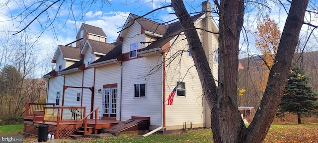 rear view of property featuring a deck