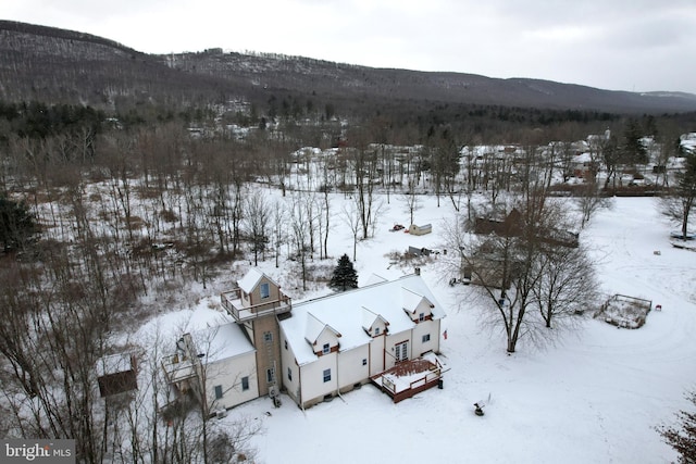 snowy aerial view featuring a mountain view