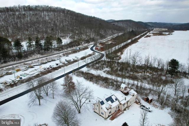 snowy aerial view featuring a mountain view