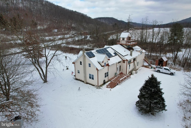 snowy aerial view featuring a mountain view