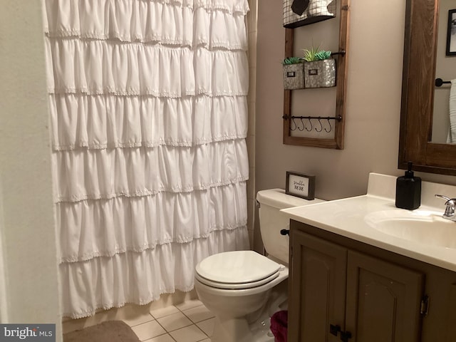 bathroom with tile patterned flooring, vanity, and toilet