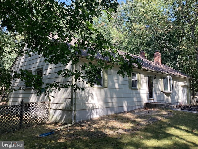 view of side of home with a yard