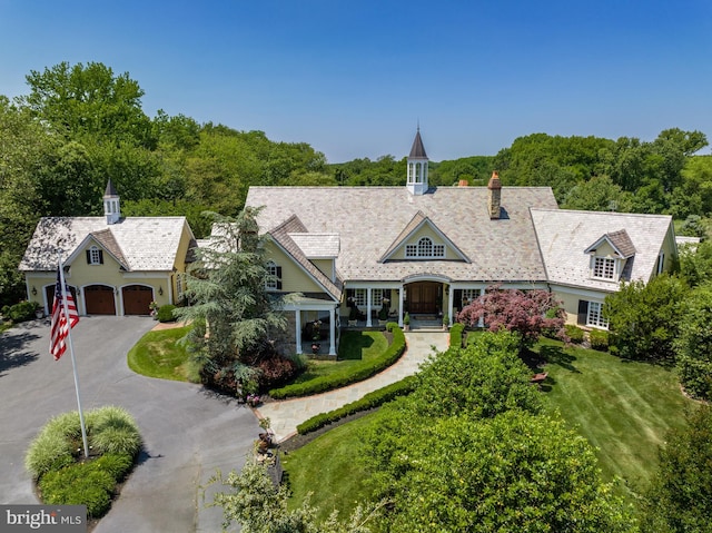 view of front of property featuring a garage and a front lawn