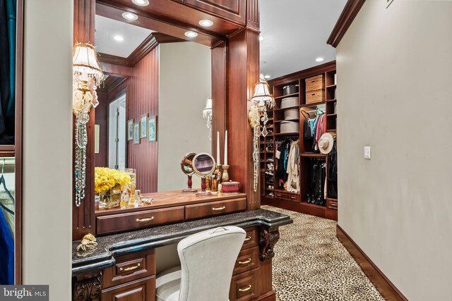 spacious closet featuring a notable chandelier and hardwood / wood-style flooring