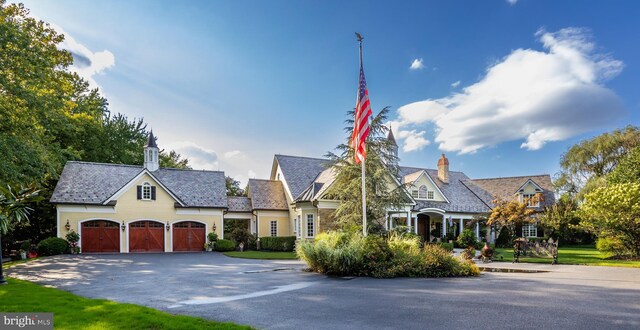 french provincial home featuring a garage