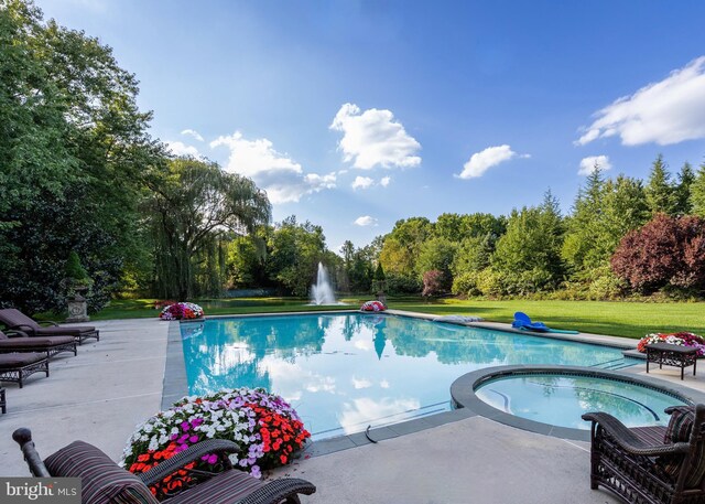 view of swimming pool with a lawn, an in ground hot tub, and a patio area