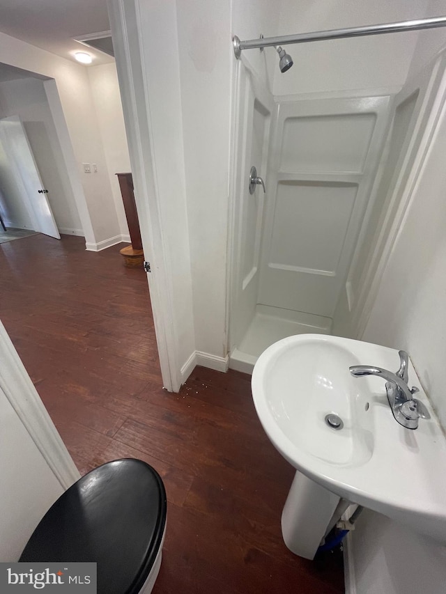 bathroom featuring hardwood / wood-style floors and walk in shower